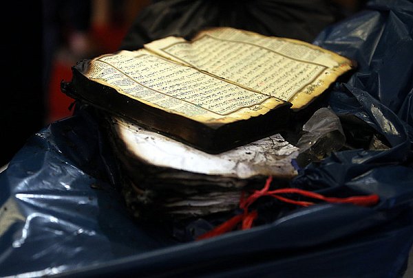 Ein von den Flammen zerstörter Koran aus dem Gebetsraum des Moscheevereins an der Herforder Straße liegt auf einer Mülltüte. - © Foto: Wolfgang Rudolf