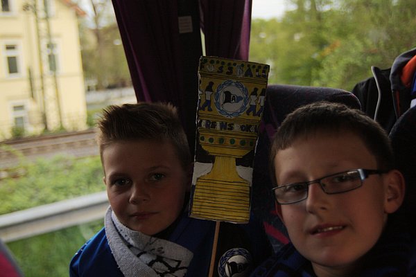 Schon immer Bielefeld-Fans: Julian und Dominik sind voller Vorfreude im Bus. Der steht auf dem Ostwestfalendamm im Stau. Zur Unterstützung haben sie einen DFB-Pokal im Arminiadesign dabei.