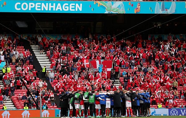 Die dänische Mannschaft schwört sich vor dem Wiederanpfiff ein. - © Friedemann Vogel/POOL EPA/AP/dpa