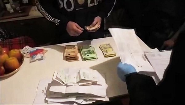 Eine Szene aus einem Video zeigt Polizeibeamte bei der Sicherstellung von Geld und Dokumenten bei der Mafia-Razzia. - © Polizia di Stato/dpa