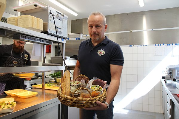 Peter Reiche von der Herforder Wirtschaft präsentiert das "Nur noch drauf"-Körbchen. Hungrige Hiddenhauser können sich mit den Delikatessen das Wochenende versüßen. - © Jan Henrik Gerdener (NW)