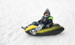 Für die ersten Rodelversuche von Mikael (7) ist der Hügel im Aaawiesenpark hoch genug, zumal das Rodelkissen kaum zu steuern ist. - Ralf Bittner
