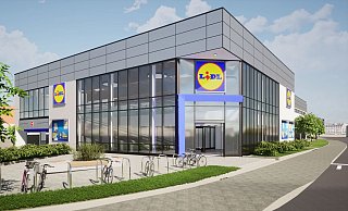 Die neue Lidl-Metropolfiliale am Stadtring: Im Erdgeschoss hinter der Glasfassade finden sich die Schleuse zur Parkgarage mit 86 Stellplätzen oder Rollstiege und Aufzug, mit der die Verkaufsfläche im Obergeschoss erreicht werden kann. - Tab-Architektur