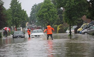Feuerwehrleute helfen Autofahrern in Bünde, die nach dem Starkregen auf der überfluteten Engerstraße feststecken. - Florian Weyand