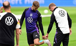 Niclas Füllkrug (M) nach seinem vergeblichen Härtetest beim Abschlusstraining im Gespräch mit Bundestrainer Julian Nagelsmann (r). - Federico Gambarini/dpa