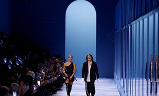 Designerin Maria Grazia Chiuri (r) geht neben einem Model. - Vianney Le Caer/Invision/AP/dpa