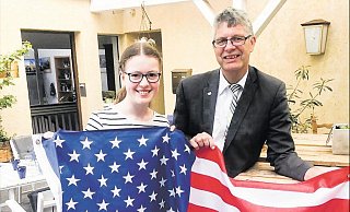 Von der heimischen Terrasse in dei große, weite Welt: Sophia Justus und Bundestagsabgeordneter Christian Haase halten die amerikanische Flagge. - Thorsten Justus