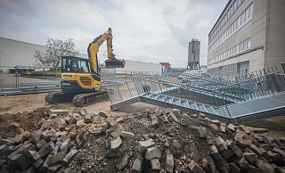 Noch liegen die Teile der Fluchttreppe und arbeitet der Bagger im Innenhof. Künftig wird hier Schulhof sein. In dem Trakt rechts sind die meisten Klassenräume. - Sarah Jonek Fotografie