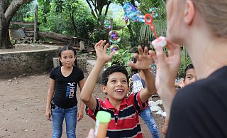 Seifenblasen fürs Foto: Auf dem Foto sind Ashly (v. l), Oliver Fernando zu sehen. Die Weltwärts-Stipendiatin Nadine Szesni (r.) ist Freiwillige im INPRHU-Projekt von Condega. - Gina Gröppel