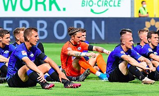 SCP-Torhüter Jannik Huth (M.) sitzt nach Spielschluss mit seinen Teamkollegen auf dem Rasen, um vor der Südtribüne mit den Fans eine Humba zu zelebrieren. - Witters