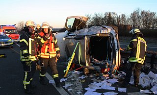 Retter der Feuerwehr haben soeben den Schwerverletzten aus dem überschlagenen Kombi befreit. - Jens Reichenbach