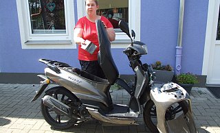 Im Juli wurde der Roller von Natascha Birkholz gestohlen und demoliert. Hier ist sie mit ihrem zerstörten Motorroller vor ihrem Domizil in der Wittekindshofer Wohngemeinschaft am Glatzer Garten zu sehen. - Karsten Schulz