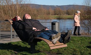 Tanja und Mike Jäcker (l.) genießen die Wintersonne auf der Rehmer Insel und lauschen dem Rauschen des Weserhochwassers im Hintergrund. - Ulf Hanke