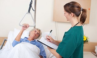 Pflegekraft im Gespräch mit einer Patientin: Frühzeitige Planung erleichtert den Übergang in die Pflege. - stock.adobe.com