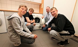 Wäschewaschen ist Teil des Kurses "Fit for Life" an der Paderborner Friedrich-Spee-Gesamtschule. Das zeigen (v.l.) Henning Hentze, Elias Mesenzew, Lehrer und Gesamtschulrektor Benjamin Eke sowie Roland Prieb. - Rajkumar Mukherjee
