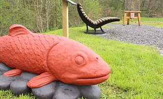 Die Skulptur einer Bachforelle ist am Wisea-von-Westpalen-Platz am östlichen Ortseingang aus Richtung Peckelsheim an der Helmerte platziert. - Burkhard Battran