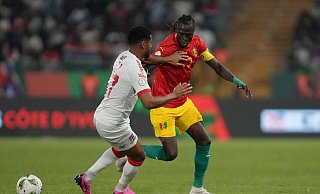 Guineas Issiaga Sylla (r) im Zweikampf mit Gambias Saidy Janko. - Sunday Alamba/AP