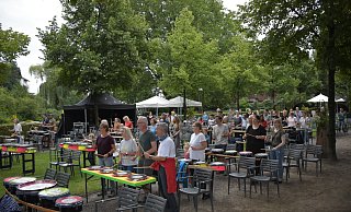 Konzentriert folgen die Teilnehmer Drumbobs Anweisungen und bringen gemeinsam den Schlossgarten beim Rudeltrommeln zum Beben. - Julia Stratmann