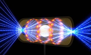 Diese Illustration zeigt ein NIF-Target-Pellet in einer Hohlraumkapsel mit Laserstrahlen, die durch Öffnungen an beiden Enden eintreten. Die Strahlen komprimieren und erhitzen das Target auf die Bedingungen, die für die Kernfusion erforderlich sind. - --/Lawrence Livermore National Laboratory/dpa