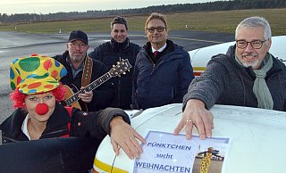 Heiligabend auf dem Rollfeld: Pfarrer-Tochter Ann- Kristin Thomas als "Pünktchen" (v.l.) mit Musiker J.P. Fair, Carsten Köhne, Lars Geertz (beide Flughafen GmbH) und Pfarrer Berthold Schneider freuen sich auf das Event. - Sibylle Kemna