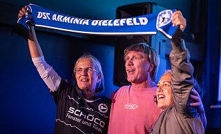 Ansgar Brinkmann stimmt bestens eingerahmt die Arminia-Hymne an. - Teresa Kröger