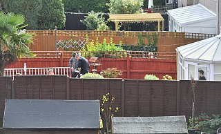 Zwischen Zäunen von Reihenhäusern: Ermittler durchsuchen in Swindon mit einem Bodenradar den Garten des Verdächtigen. - picture alliance / empics