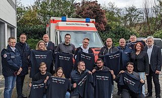 Zum Dank für ihren langjährigen ehrenamtlichen Einsatz erhielten die Rotkreuz-Sanitäter ein T-Shirt mit dem Aufdruck „Retter mit Herz“. - DRK