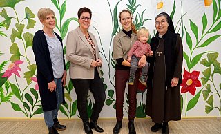 Das große Wandgemälde im Eingangsbereich ist schon fertig. Auf die Eröffnung des Kinderhauses „Kleine Freunde“ im Januar freuen sich (v.l.) Diana Ahlers, Elke Michaelis, Marlen Karthaus mit Kind und Schwester M. Angela Benoit. Foto: Michael Bodin - Michael Bodin