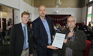 Andreas Schröder (l.) und Detlef Neuß (3. v. l.) vom Fahrgastverband "Pro Bahn" verleihen Kai Schulte vom Kompetenzzentrum Integraler Taktfahrplan einen Preis des Fahrgastverbands. - Ulf Hanke