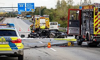 Der Unfallort am 10. Oktober: Feuerwehrfahrzeuge stehen bei dem ausgebrannten Lamborghini auf der Autobahn 66. - picture alliance/dpa/Wiesbaden112.de