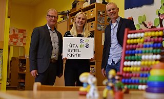 Bürgermeister Thomas Meyer (v. l.), Kita-Leiterin Celine Kucharewa und Bertram Schwade (Ev. Jugendhilfe Schweicheln) präsentieren das Logo der Kita Spielkiste. - Evangelische Jugendhilfe Schweicheln