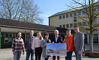 Matthias Daniel (Elternvertreter, v.l.), Michael Graßhoff (Bauamt), Bettina Neumann (OGS-Leitung), Dagmar Schmidt (stellvertretende Schulleiterin), Hubertus Grimm (Bürgermeister), Birgit Riepe-Dewender (Schulleiterin) und Stefan Gördemann (Schulamt) zeigen den geplanten Neu- und Anbau. - Nicole Fischer