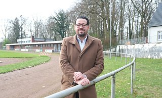 Manuel Pierri vom Vorstand des Bünder Sport-Vereins 08/09 e.V. steht im Erich-Martens-Stadion. Die Mauer im Hintergrund könnte einen frischen Anstrich vertragen. Am Sportlerheim, das nicht barrierefrei ist, steht nach Meinung des Vereins eine vernünftige Sanierung ebenfalls noch aus. - Katharina Eisele