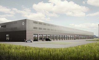 Die rückwärtige Ansicht zeigt den fast 200 Meter langen Gebäuderiegel mit den Werkstatthallen und der Fahrzeugaufbereitung sowie dem Parkhaus auf zwei Ebenen. Auch eine solitäre Werbeanlage fehlt nicht. - GJL Architekten