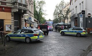 Archivbild aus dem Jahr 2019: In dem Rettungswagen, der kurz nach der Massenschlägerei auf der Steinstraße steht, wird ein verletzter Mann behandelt. Das Gebäude rechts ist inzwischen abgerissen. - Jobst Lüdeking