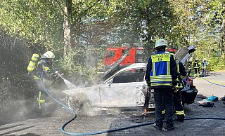 Immer wieder lodern kleine Glutnester in dem BMW auf. Mit einem gezielten Löschangriff bekommen die Feuerwehrleute den Brand schließlich in den Griff. Foto: Thorsten Heß - Thorsten Heß