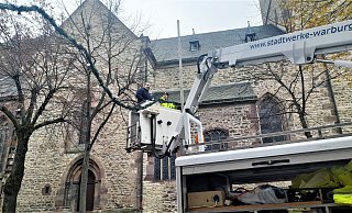 Thomas Orth und Hannes Winter im Hubkorb im Bereich der Neustadtkirche mit einer der Lichterketten über die Hauptstraße. - Simone Flörke