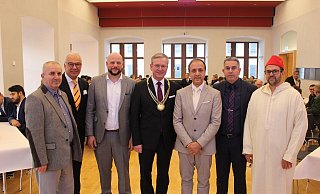 Imam Ismail Albayrak (v.l.), Emin Özel (Schura Paderborn), Aaron Langenfeld (Theologische Fakultät), Bürgermeister Michael Dreier, Abdul Ghafar Sahak (Schura Paderborn), Recep Alpan (Integrationsrat) und Imam Morad Tassamart gemeinsam mit den Gästen des Fastenbrechens im Rathaus. - Stadt Paderborn / Moritz Jülich