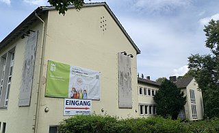 Ein großer bunter Banner weist die ehemalige Pestalozzischule an der Otto-Brenner-Straße jetzt als Grundschule Sieker aus. - Ivonne Michel