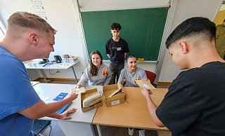 Ah, so geht's: Erstwähler Anthony (16, l.) und Bora (16, r.) holen sich von Paula und Soziala (hinten, v.l.) ihre Briefwahlunterlagen ab und lassen sich erklären, was zu beachten ist. Massimo Hebestadt (hinten Mitte), Azubi zum Verwaltungswirt bei der Stadt, unterstützt die Schüler bei der Durchführung der Wahl in der Luisenschule. - Andreas Zobe