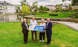 Landrat Christoph Rüther (v.l.) und der technische Dezernent des Kreises, Martin Hübner, überreichen den symbolischen Scheck über 250.000 Euro für die Neupflanzungen an Claudia Warnecke, technische Beigeordnete, und Bürgermeister Michael Dreier. - Lina Loos Fotografie