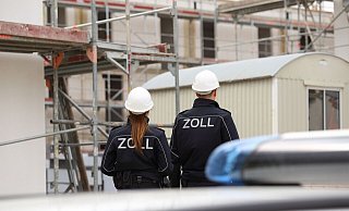 Zoll-Ermittler untersuchen eine Baustelle. - Zoll