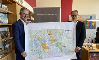 Bürgermeister Michael Dreier (l.) und Glasfaser-Nordwest-Geschäftsführer Andreas Mayer zeigen die Pläne für Paderborn. - Glasfaser Nordwest