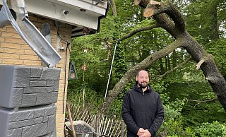 Tom Brinkmann-Clasberg steht auf seiner Terrasse - in der Luft hängt der Rest des Siel-Baumes, der nun von einer Fachfirma beseitigt wurde. - Nicole Sielermann