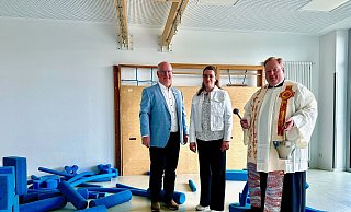 Segen auch für den neuen Mehrzweckraum mit Turngeräten: Detlef Müller, Carolin Fleckner und Pfarrer Tobias Dirksmeier. - Christian Schlichter