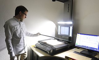 Der neue Scanner macht ein Bild von oben. Damit alles einheitlich ist, muss Patrik Stuke Bildausschnitt und Buchwaage immer mal wieder neu ausrichten und anpassen. - Judith Gladow