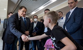Bundesgesundheitsminster Karl Lauterbach (l) beim Klinikbesuch in Lwiw. Er begrüßt einen Jungen, dessen Mutter und Schwester bei einem Bombenangriff schwer verletzt wurden und hier behandelt werden. - Foto: Thomas Koehler/Photothek.De/Thomas Koehler/photothek.de/dpa