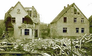 Das Foto zeigt zwei durch den Bombenangriff beschädigte Häuser in der Hindenburgstraße. Im Vordergrund liegen Trümmer des Hauses Scheideler. - Polizist Gnuse