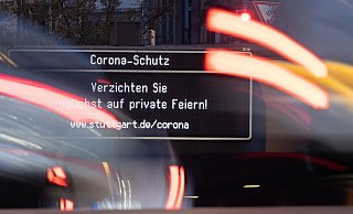 Die Anzeige «Corona-Schutz. Verzichten Sie möglichst auf private Feiern!» leuchtet in Stuttgart. - Foto: Sebastian Gollnow/dpa/Archivbild