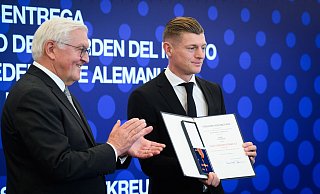 Bundespräsident Steinmeier (l) nennt ihn eine lebende Legende und zeichnet ihn aus: Ex-Nationalspieler Kroos (r). - Bernd von Jutrczenka/dpa